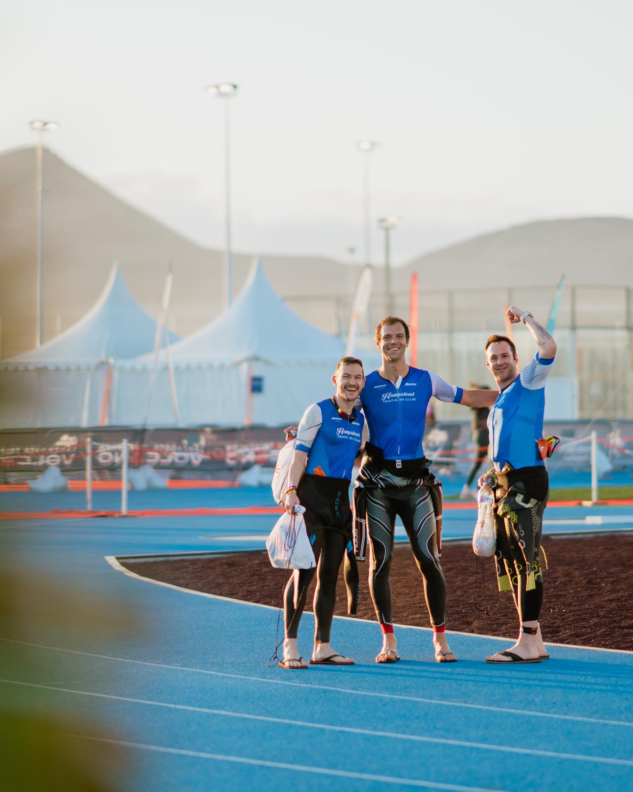 Three participants waving at the camera after a day of triathlon training