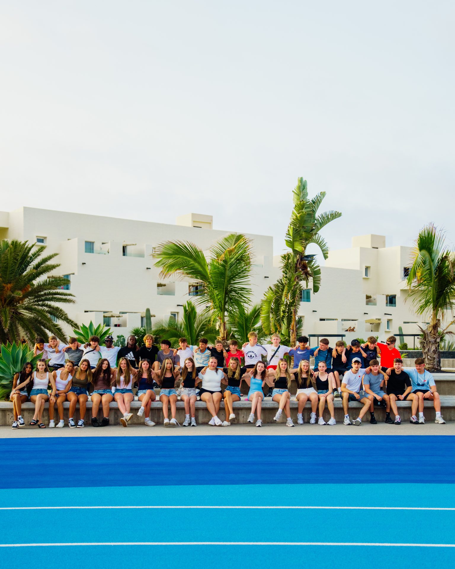 A school group sitting for a group photo at Club La Santa