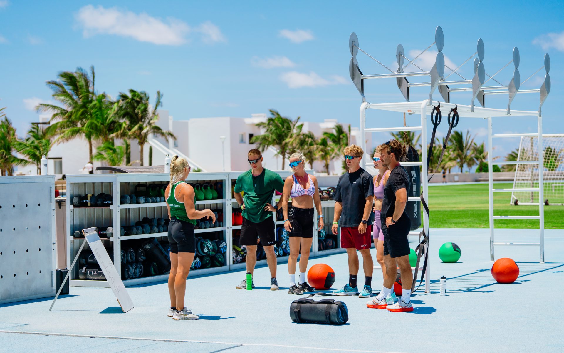 A Green Team instructor leading guests in a HYROX class at Club La Santa